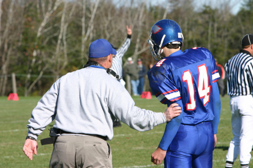 football coach calling a play from the sidelinesCoaching lightbox http://www.istockphoto.com/my_lightbox_contents.phplightboxID=967198Other football photos.
