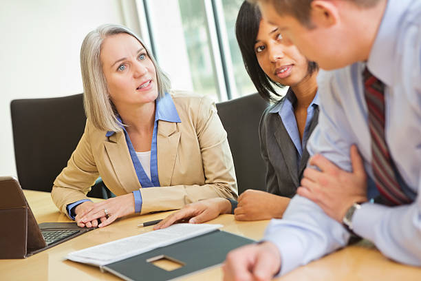 istock Mature executive having discussion with colleagues in board room meeting 174895816