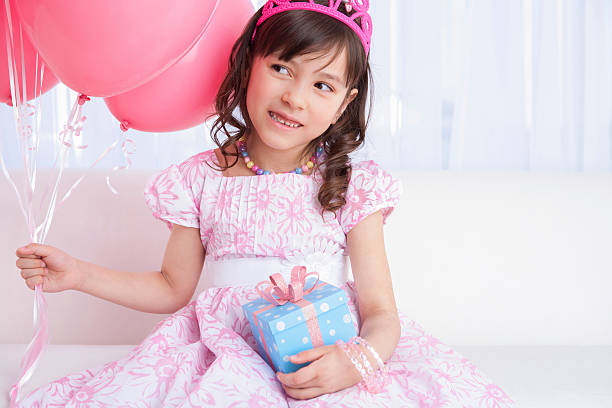 istock Excited birthday girl holding a gift 174895924