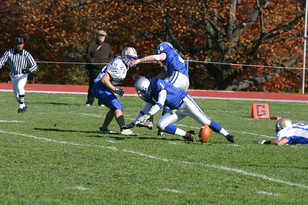 football player fumbles the ballVisit youth sports lightbox http://www.istockphoto.com/my_lightbox_contents.phplightboxID=21510Other football photos.