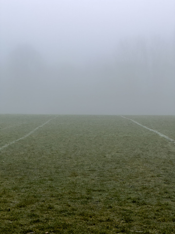 A foggy British communal sports field for football and rugby