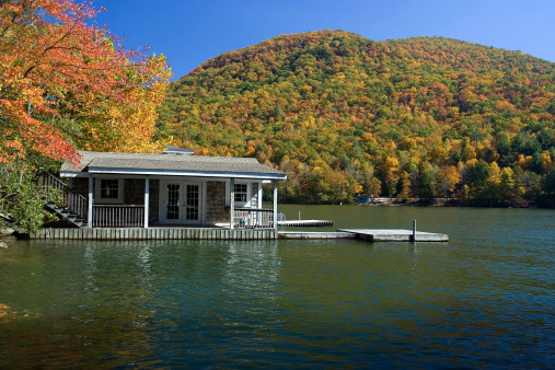 Charming boathouse in Lake Burton (Georgia) with beautiful fall color in the background.