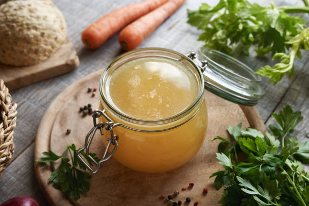 istock Chicken bone broth in a glass jar with fresh vegetables 1748967059