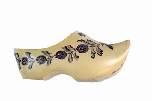 Souvenir from Holland ; a handmade and hand-painted miniature Dutch wooden shoe, isolated on white. Clog is 3.2 inches long.