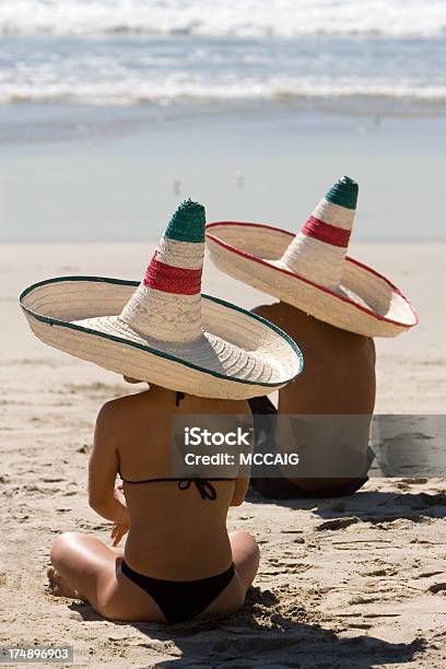Couple On Beach With Sombrero Hats Stock Photo - Download Image Now - Adult, Beach, Beautiful People