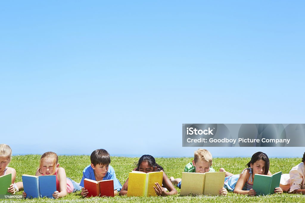 Disfrute de un libro en el parque - Foto de stock de Acostado libre de derechos