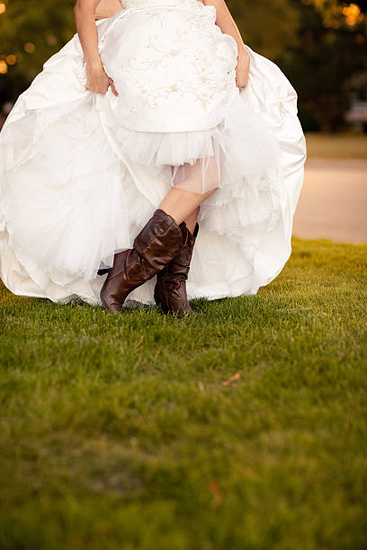 Color Image Of Bride Showing Off Her Cowboy Boots Stock Photo - Download  Image Now - Cowgirl, Wedding, Wedding Dress - iStock