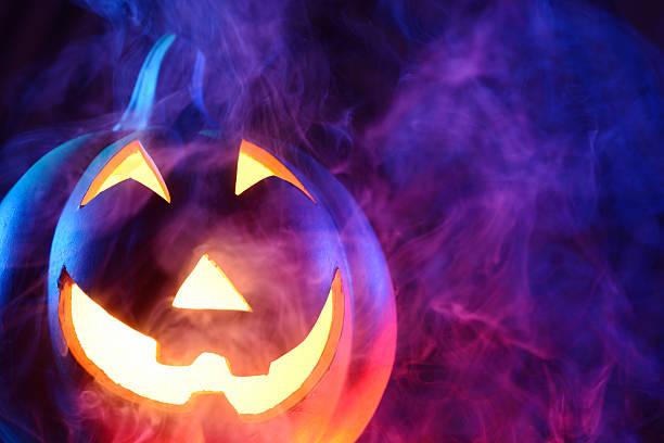 istock Halloween pumpkin with colorful smoke 174897246
