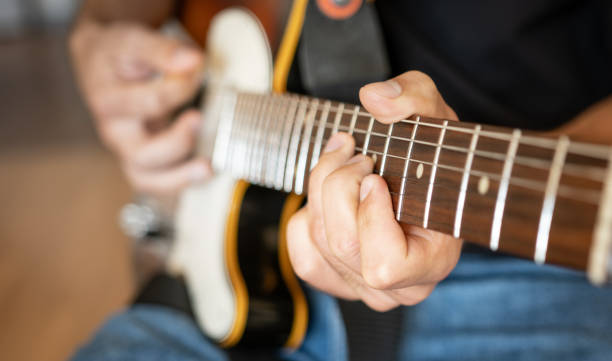 istock Man hand playing on electric guitar 1748972492