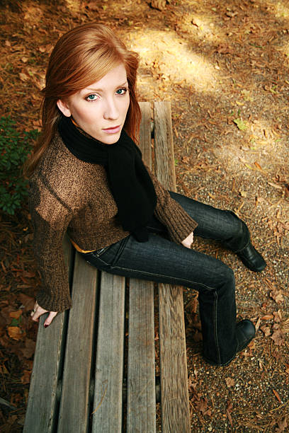 Redhead from Above young woman (twenty-one) on a bench outside - shot from above modelce stock pictures, royalty-free photos & images
