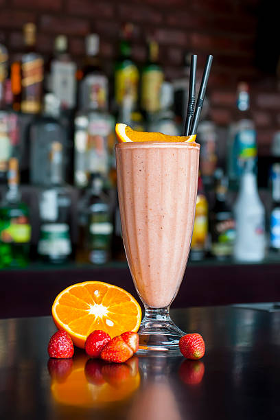 non-alcoholic strawberry milkshake cocktail on the classic black bar table stock photo