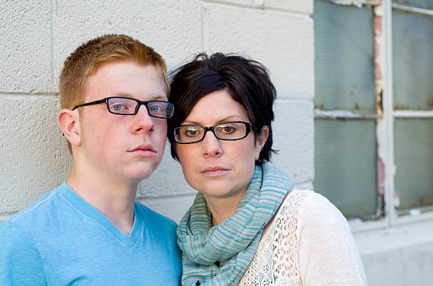 serious mother and son in despair a mother and son look seriously at the camera appearing sad and desperate michigan photos stock pictures, royalty-free photos & images