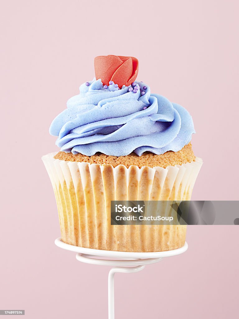 Cupcake Delicious cupcake topped with buttercream. Pink background. Anniversary Stock Photo