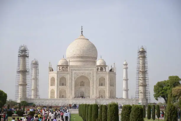 The Taj Mahal is an ivory-white marble mausoleum on the right bank of the river Yamuna in Agra, Uttar Pradesh, India. This photo was taken when taj mahal renovation work is on going.