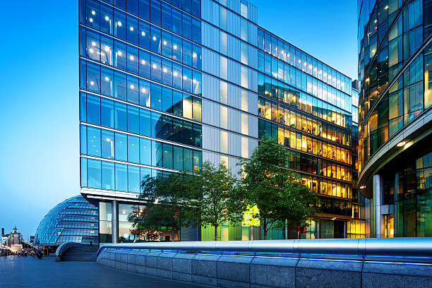 Illuminated Office Buildings at Night in London Illuminated Office Buildings at Night in LondonCity Hall on the left side gla building stock pictures, royalty-free photos & images