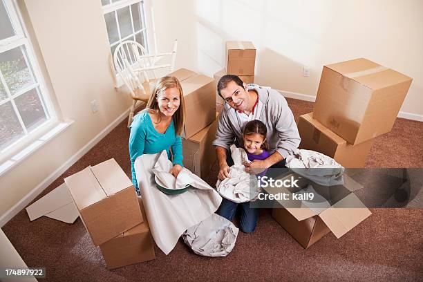 Family Packing Moving Boxes Stock Photo - Download Image Now - 30-39 Years, 6-7 Years, Adult