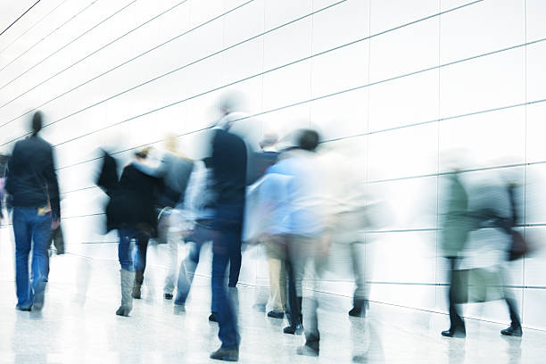istock People Walking Through The White Hallway 174898119