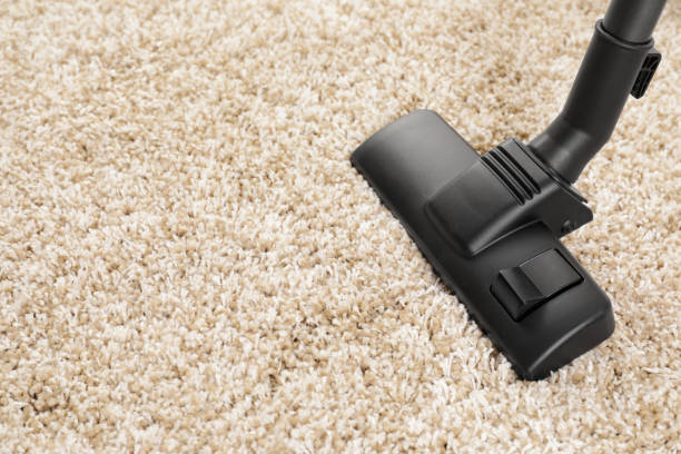 istock Hoovering carpet with modern vacuum cleaner indoors, closeup. Space for text 1748987110