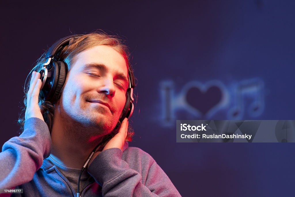 Portrait of young man enjoying music. A young man listening to classic music, inscription of   I love music in the background. Listening Stock Photo