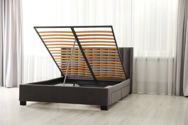 istock Modern bed with storage space for bedding under lifted slatted base in room 1748989861