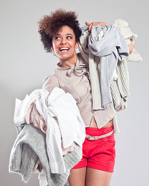 istock Happy Young Woman carrying clothes 174899265