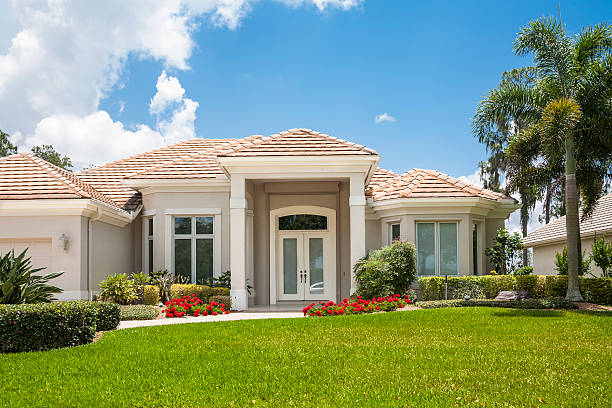 istock New Upscale Home with Flowers, Palm Trees and Front Lawn 174900008