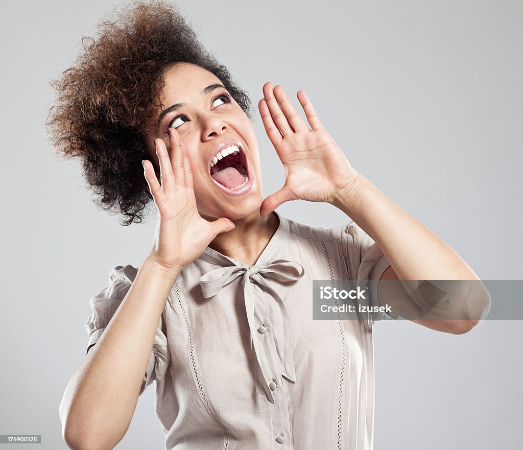 Teen Girl shouting Portrait of cute teen afro girl looking up and shouting. Shouting Stock Photo
