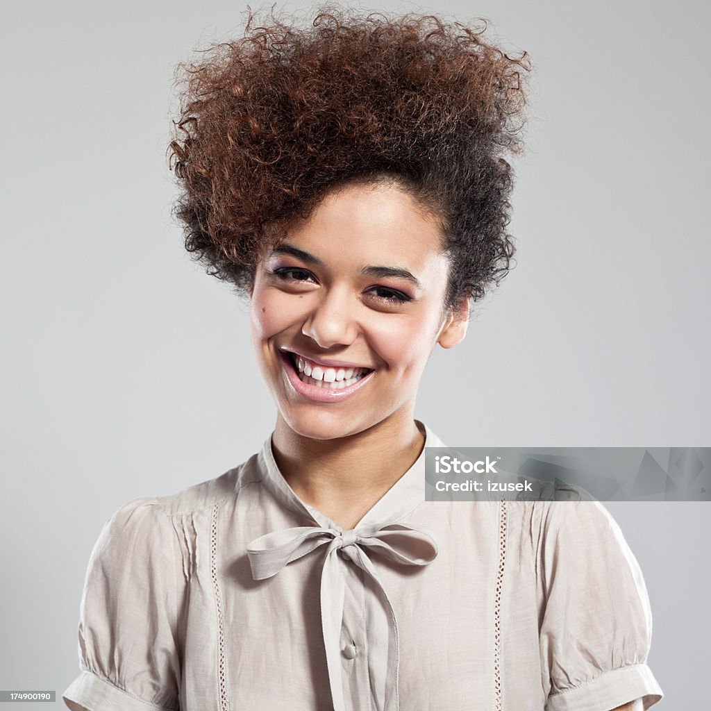 Happy Teen Girl Portrait of beautiful teen afro girl laughing at the camera. Studio Shot Stock Photo