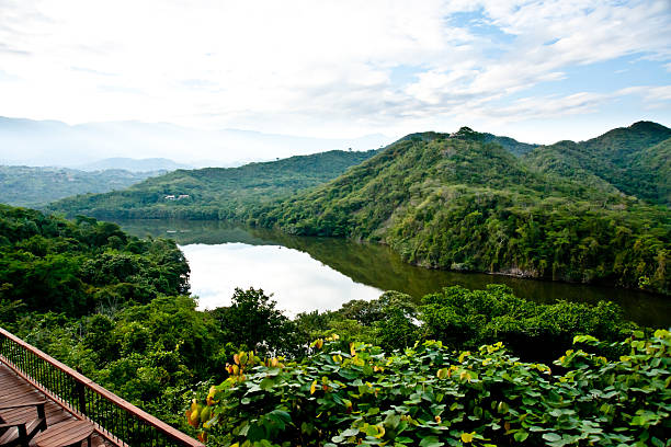 lush mountains and river in a sunny summer afternoon