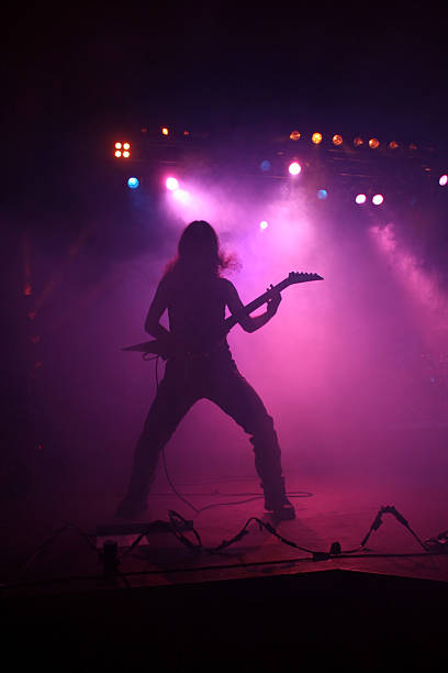 istock Pink silhouette of a guitarist on stage 174900451