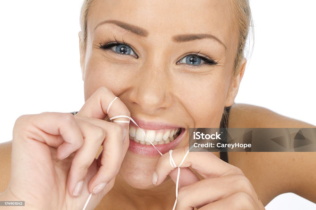 dental hygiene close up of woman flossing her teeth as a dental hygiene concept 20-29 Years Stock Photo