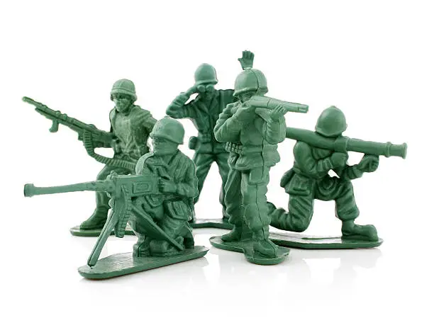 Photo of Four isolated toy soldiers on a white background