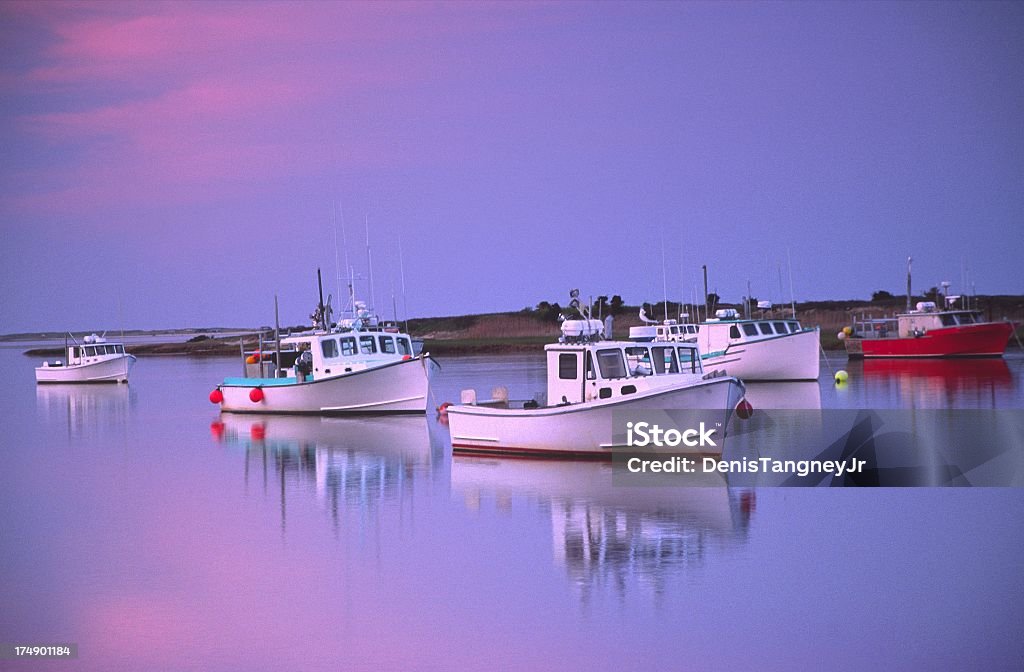 Maritime Reflections Fishing boats reflecting on the glassy Chatham Harbor Massachusetts Stock Photo