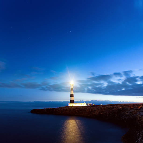 Lighthouse Mediterranean lighthouse in Menorca. Far de Artrutx. Minorca. Spain. lighthouse lighting equipment reflection rock stock pictures, royalty-free photos & images