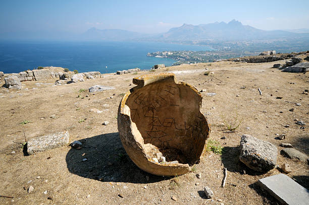 Cracked vase at ruined structure against mountain, Crete, Greece