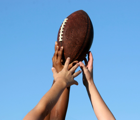 Teammates holding a football