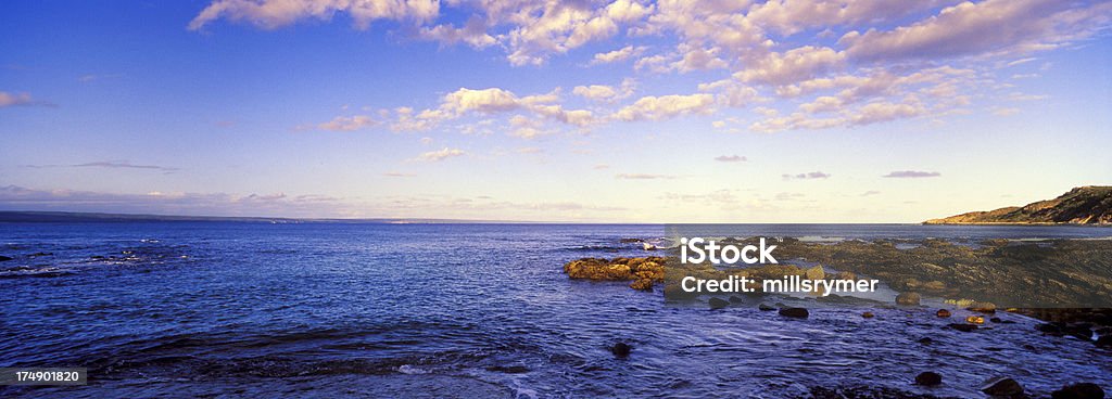 Southern Right Sea # 5 "xPan shot of late afternoon pink sunset sky, indigo blue water and highlighted rock pools looking outward towards the bayTo see similar use keyword tag or just click on the phrases below:" Bay of Water Stock Photo