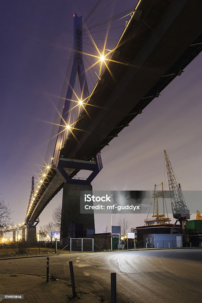 Hamburg, bridge and industrie in the harbour The Hamburg Koehlbrandbruecke (harbour bridge) during the blue hour after sunset. Taken with: Canon EOS 5D Mark 3 /24mm 1.4L ii Blue Stock Photo