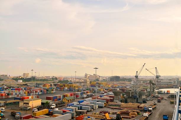 Tema Dockside Business "The port of Tema, Ghana is constant flurry of activity with many type of heavy industrial equipment visible in addition to the normal oil tanks and shipping containers" level luffing crane stock pictures, royalty-free photos & images