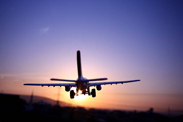 istock Airplane Flying Up Against The Sunset 174902338