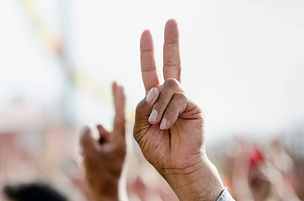 Hand making peace sign during a political rally An anonymous hand is making a peace sign during a political protest meeting.See also kurdistan stock pictures, royalty-free photos & images