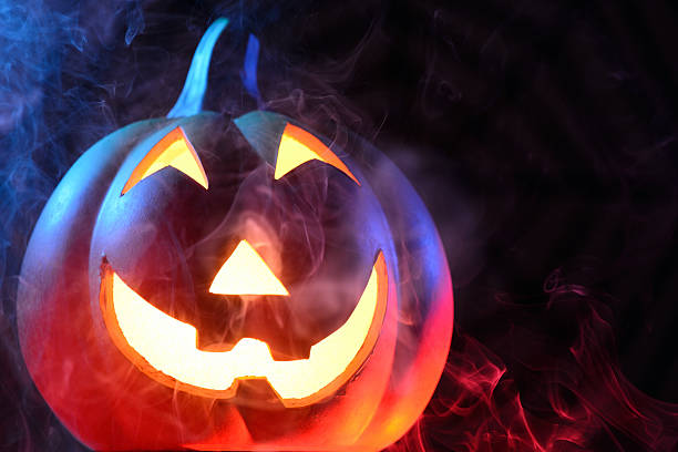 istock Halloween pumpkin with colorful smoke 174902427