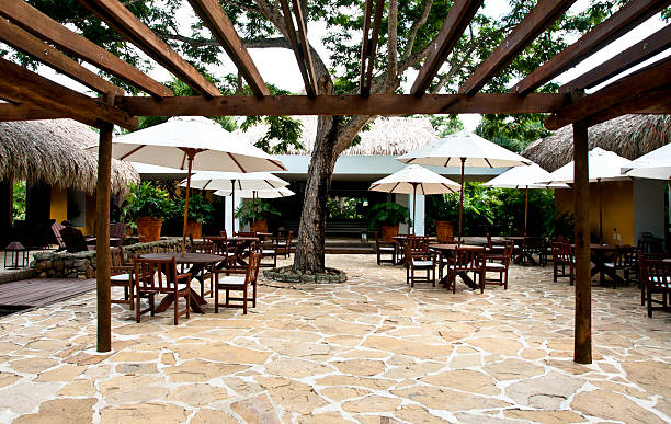 istock luxury hotel: tables and chairs with white umbrellas 174902551