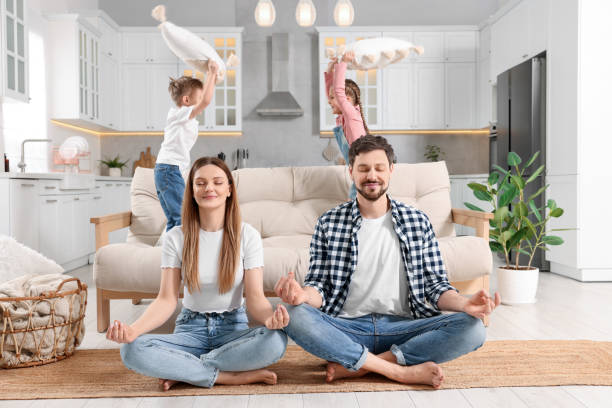 istock Parents meditating while their children playing with cushions at home 1749037352