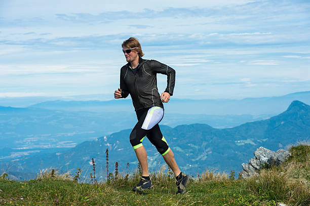 istock Young man reaching the mountain peak 174903892