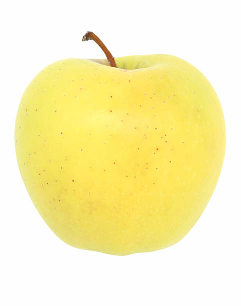 Golden Delicious apple against a white background stock photo