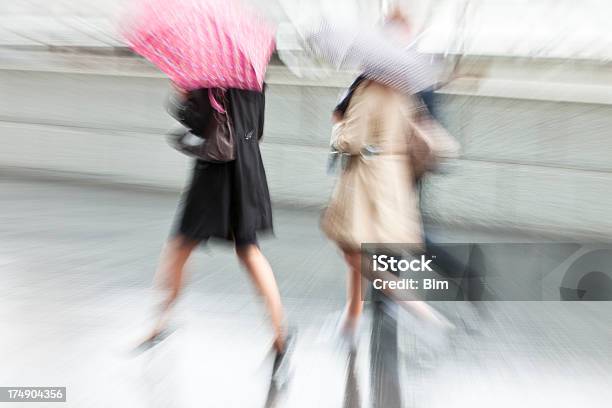 Two Young Women Walking With Umbrellas In Rainy Day London Stock Photo - Download Image Now