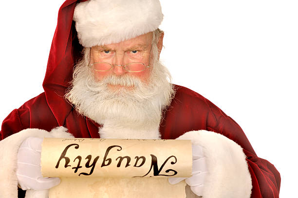 santa looking at naughty список - шалость стоковые фото и изображения