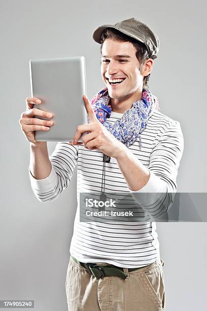 Young Man Using Digital Tablet Stock Photo - Download Image Now - 20-24 Years, Adult, Adults Only