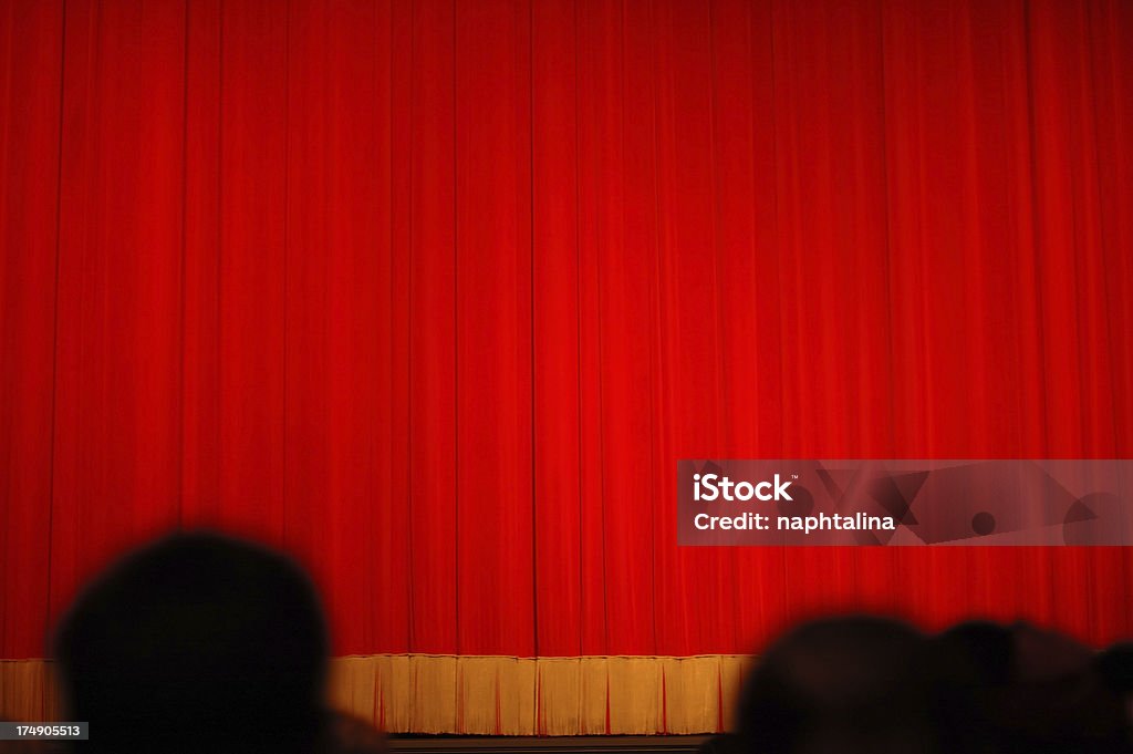 Show time Curtain with blurred people sitting for the show. Movie Theater Stock Photo